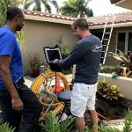 plumber inspecting pipe through video camera Boca Raton, FL