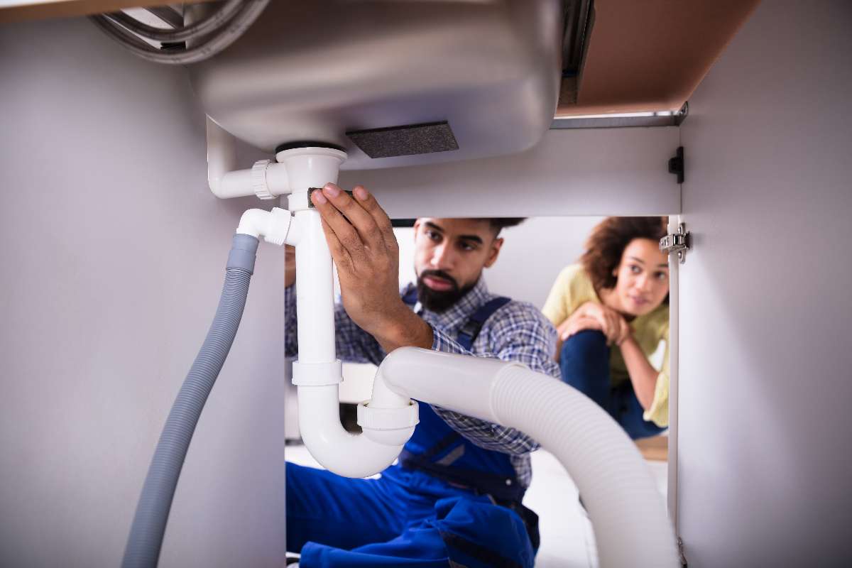Plumber Fixing Kitchen Sink Pipe Plumber Fixing Kitchen Sink Pipe Jupiter, FL