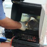 Technician monitoring a sewer video feed